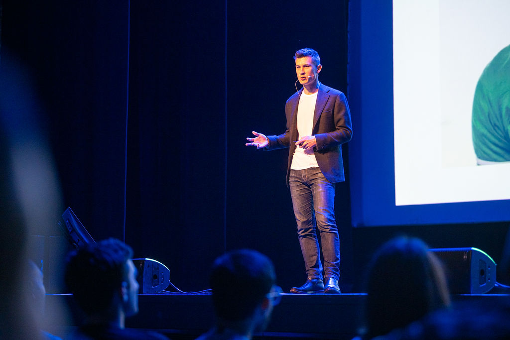 Michael Sankey speaking on stage at a marketing industry event